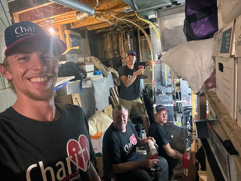 brian working in basement with two sons and employee